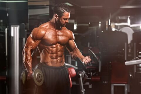 Person lifting weights with visible muscle growth in arms and legs, representing hypertrophy progress.